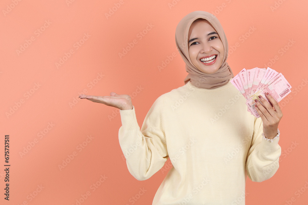 showing at banner advertisement, holding cash money rupiah Indonesia cash showing at banner advertisement, holding cash money rupiah Indonesia cash
