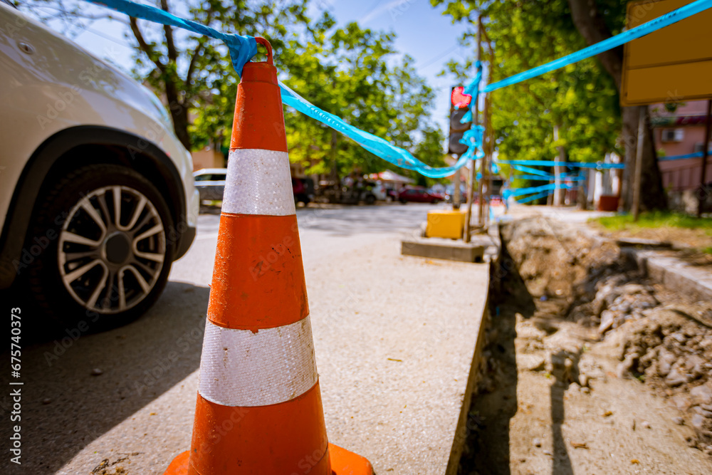 Traffic cone tied, connected, with blue warning tape