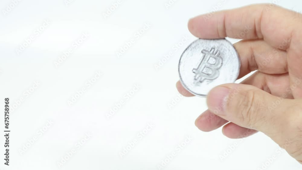 Bitcoin digital currency symbol held in man's hand. Blurred foreground on white background. Bitcoin digital currency symbol held in man's hand. Blurred foreground on white background.