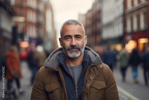 Portrait of a senior man with grey beard in the city. © Nerea