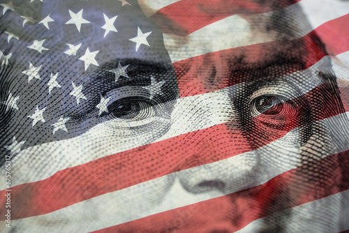 Closeup Benjamin Franklin face on USD banknote with USA flag and stock market chart graph for currency exchange and global trade forex concept. photo