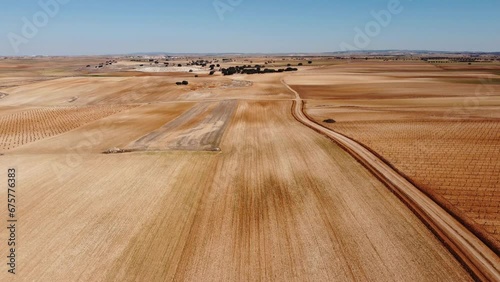 Aerial view of dry fields and lines. Drone footage in Castilla la Mancha, land of don quijote, vineyards, flat land, cereals, dirt tracks and paths. Horcajo de Santiago in 4K with DJI Mini 2 photo