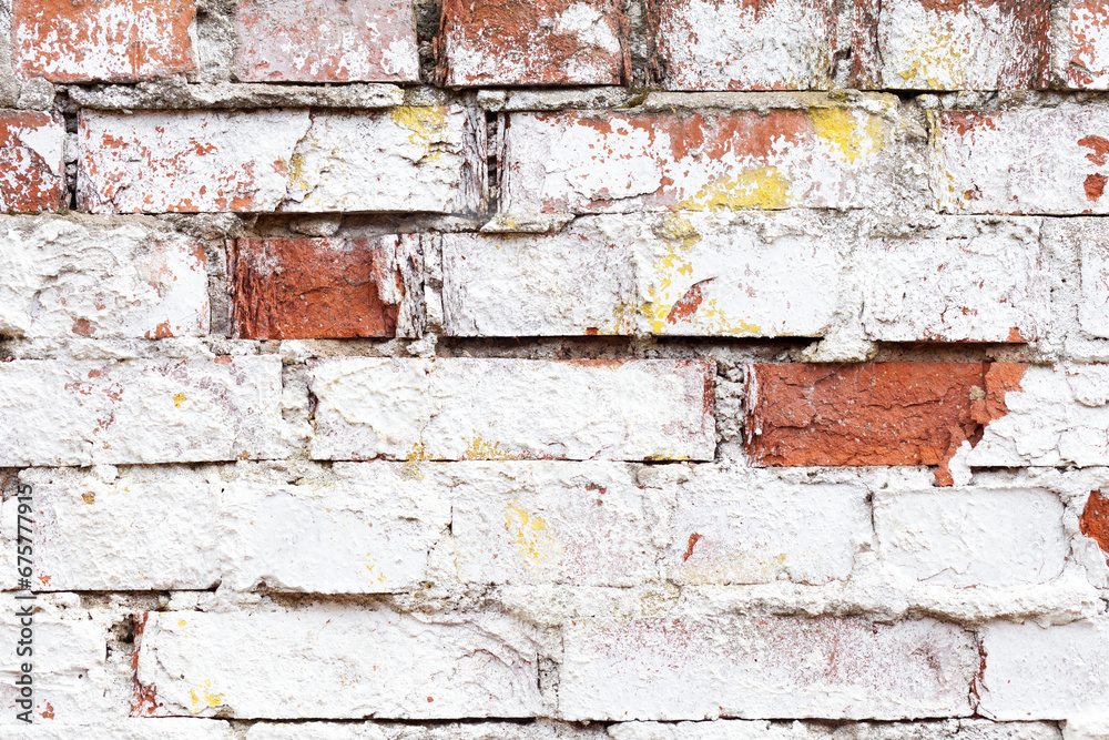 Old brick wall with white cracked paint. Rough brick wall texture. Abstract brick wall background for design. Close up. Old brick wall with white cracked paint. Rough brick wall texture. Abstract brick wall background for design. Close up.