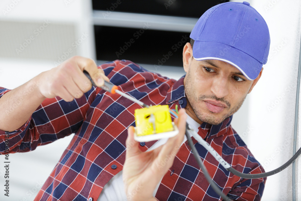 electrician man installing switch with screwdriver electrician man installing switch with screwdriver