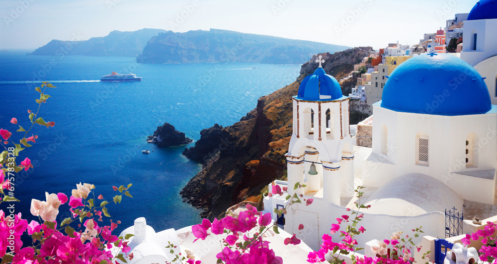 Fototapeta premium volcano caldera with blue church domes, Oia with flowers, Santorini, toned