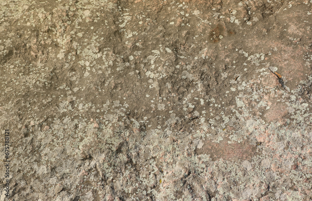 Closeup of the rough stone texture of a big rock surface for natural background concepts. Closeup dirty natural stone background texture in warm tones Closeup of the rough stone texture of a big rock surface for natural background concepts. Closeup dirty natural stone background texture in warm tones
