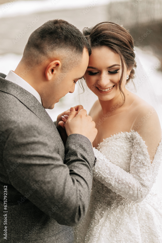The groom holds the bride's hands. Sincere emotions. A walk in the forest. Winter wedding The groom holds the bride's hands. Sincere emotions. A walk in the forest. Winter wedding