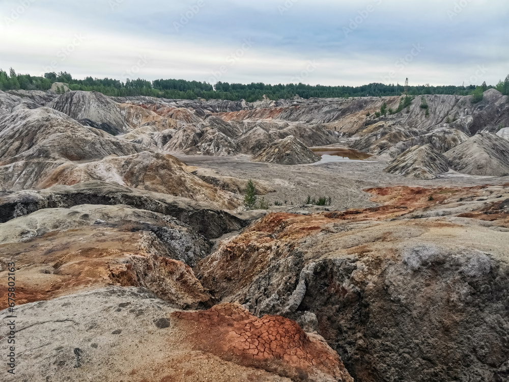 Obraz premium Ural Mars. An extraordinarily beautiful summer landscape with red lakes, colorful slopes and forest. A picturesque mountain range. Natural landscape, impressive sky. Nature of the Urals. 4K