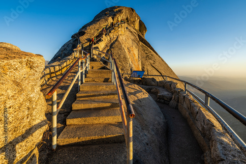 Stairs leading up to touristic viewpoint Moro Rock in Sequoia National Park during sunset. 