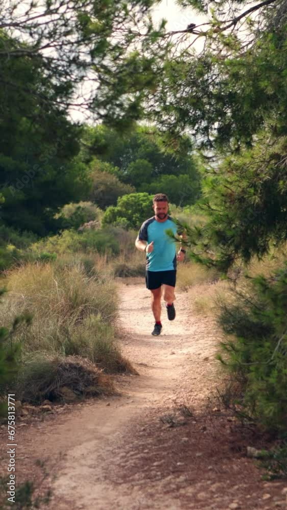 Athletic man running in a forest Athletic man running in a forest