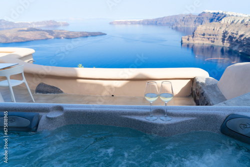 clear jacussi pool water and view of Santorini caldera, Greece photo