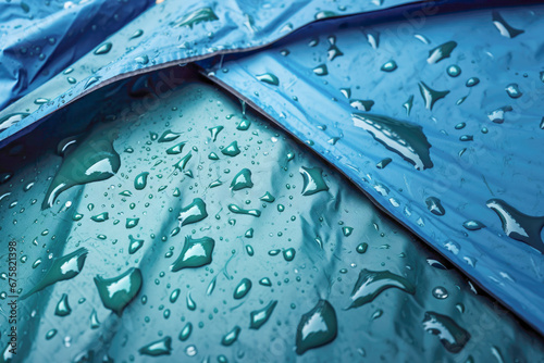 A waterproof tent stands ready for a camping adventure as raindrops bead on its surface, showcasing the effective rain-repelling membrane.