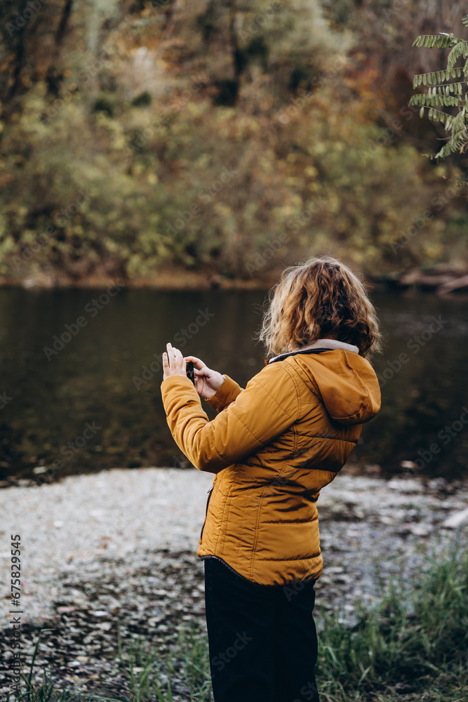 person take a photo on a phone in the river person take a photo on a phone in the river