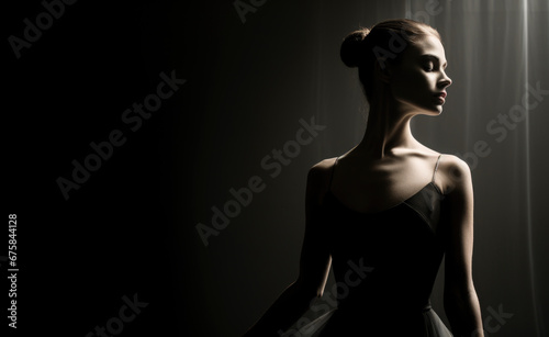 Professional ballet dancer performing in the dark lighted room