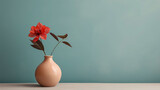 Closeup of plant with red blossom in vase isaolted on pastell blue background, standing on grey ground, also for presentation