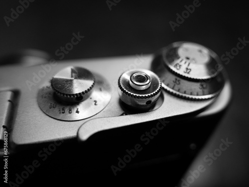 Grayscale shot of the small parts of an old vintage camera