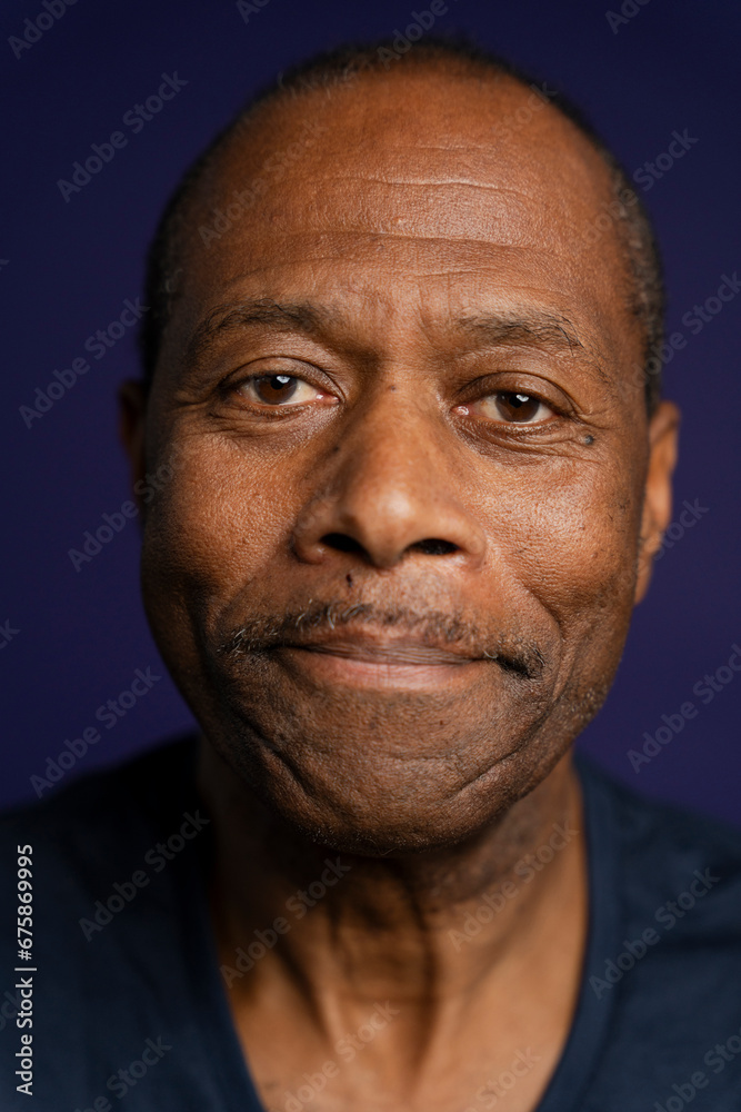 Portrait of smiling man with mustache against purple background Portrait of smiling man with mustache against purple background