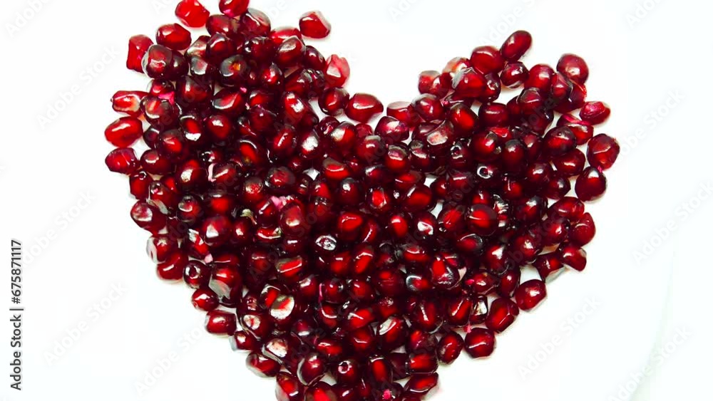 Heart shaped pomegranate fruit berries on a white background