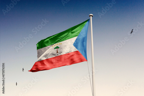 Equatorial Guinea flag fluttering in the wind on sky.