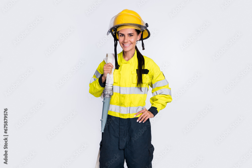 Photo of young attractive woman firefighter happy positive smile hold hose isolated over white color background Photo of young attractive woman firefighter happy positive smile hold hose isolated over white color background