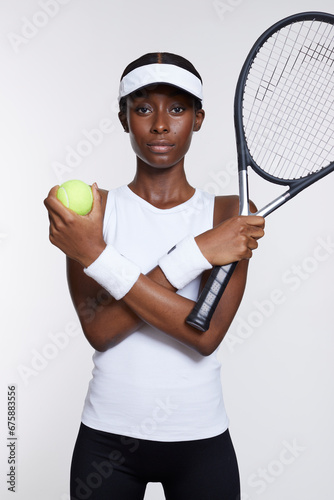 Studio portrait of athletic woman with tennis racket and ball © Cultura Creative