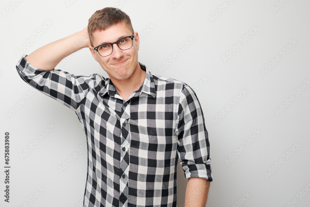 Portrait of clever man in shirt touching head thinks doubts chooses isolated on white studio background with copy space Portrait of clever man in shirt touching head thinks doubts chooses isolated on white studio background with copy space