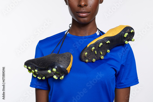 Mid section of woman with soccer shoes