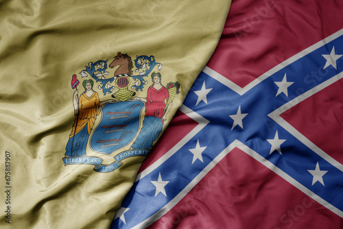 big waving colorful confederate jack flag and flag of new jersey state .