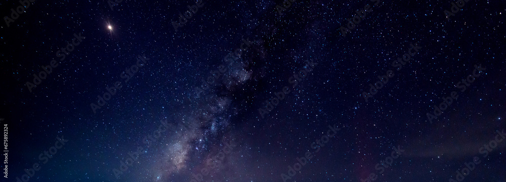 Fototapeta premium Panorama blue night sky milky way and star on dark background.Universe filled with stars, nebula and galaxy with noise and grain.Photo by long exposure and select white balance.