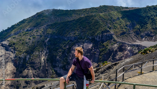 COSTA-RICA VOLCANO MOUNTAINS copy space travel background image, natural light landscape, white man tourist enjoying the view photo