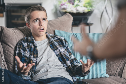 Teenage boy arguing and unhappy with parent photo