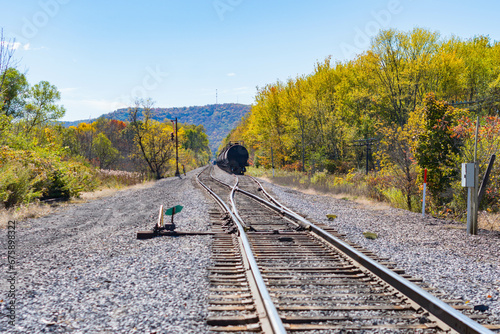 Train tracks with fuel tanker train conteiners deminishing perspective train tracks, fall season perfect day atural background.