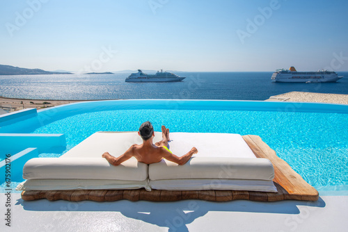 Man relaxes on the sunbed at Mykonos, Greece