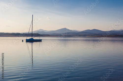 Sailing boat anchored on the shore of the Gabriel y Galan reservoir
