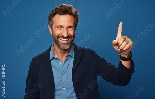 Smiling Forty-year-old business man on a plain blue background points up his finger. Generative AI	