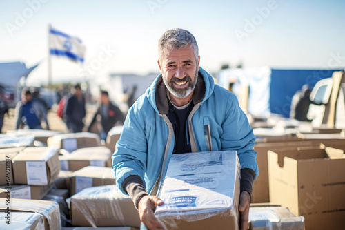Male volunteers unload, collect, and distribute boxes of humanitarian aid to war-affected civilians and refugees from the conflict, ensuring their safety and well-being during this crisis