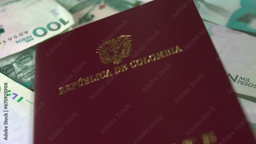 Colombian passport Slowmotion on Colombian money COP Colombian passport Slowmotion on Colombian money COP