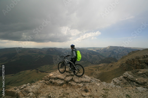 A cyclist rides in the Caucasus mountains, the Bermamyt plateau, Russia.