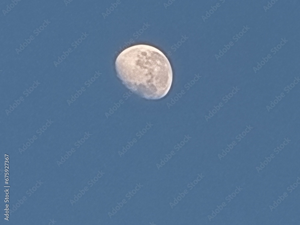 half moon in the blue sky in the morning