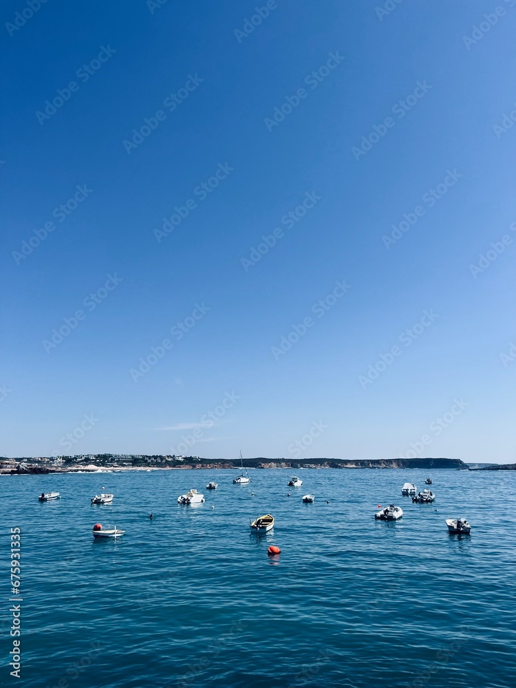 Small fishing boats at the blue sea, blue clear sky