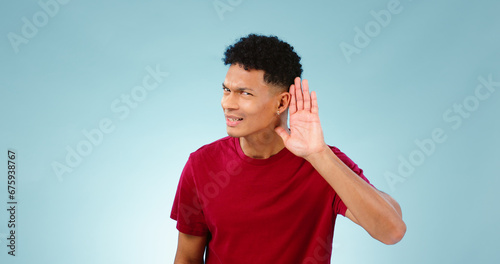 Foto Portrait, overhearing and hand gesture for eavesdropping with a man listening in studio on a blue background