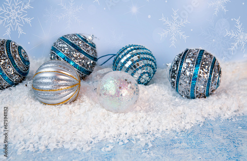 Christmas mood, New Year background. Sparkling Christmas balls on the snow. Holiday atmosphere.