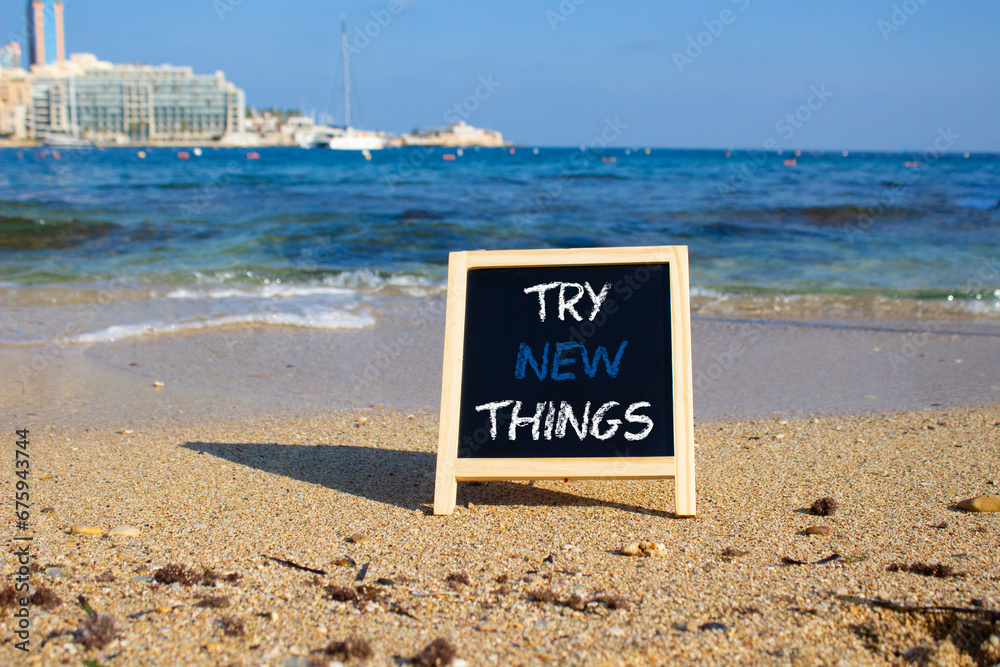 Try new Things symbol. Concept words Try new Things on black chalk blackboard blocks. Beautiful sea green background. Business and Try new Things concept. Copy space.