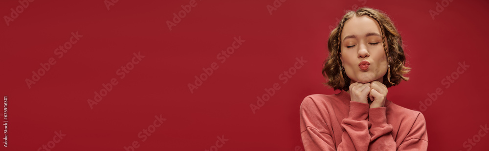 portrait of young pretty woman with short wavy hair and braids pouting lips on red, air kiss banner portrait of young pretty woman with short wavy hair and braids pouting lips on red, air kiss banner