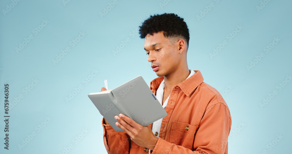 Thinking, notebook and writing with man, planning and ideas with creativity on a blue studio background. Person, guy and model with problem solving, vision or education with student and knowledge Thinking, notebook and writing with man, planning and ideas with creativity on a blue studio background. Person, guy and model with problem solving, vision or education with student and knowledge