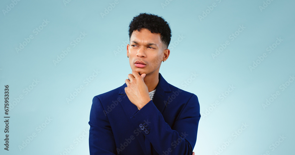 Man, thinking with idea in studio or decision and planning problem solving by blue background. Young, brazil and person in thought for creative solution, project insight and choice by mock up space Man, thinking with idea in studio or decision and planning problem solving by blue background. Young, brazil and person in thought for creative solution, project insight and choice by mock up space