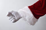 Santa Claus hand with clenched fist wearing gloves dressed traditionally