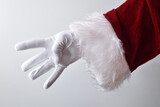 Santa Claus hand showing four fingers wearing gloves dressed traditionally