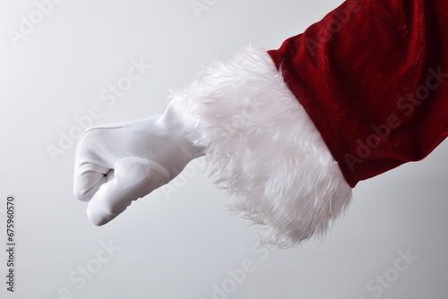 Santa Claus hand with clenched fist upside down wearing.