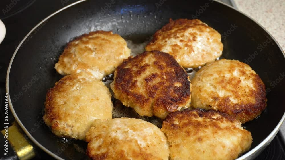 Red fish cutlets are fried in a frying pan. Cooking master class. Video recipe. 4k footage. Red fish cutlets are fried in a frying pan. Cooking master class. Video recipe. 4k footage.
